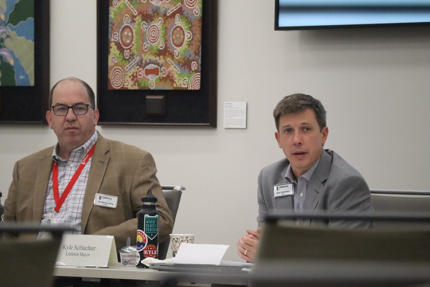 Littleton City Manager Jim Becklenberg, left, and Mayor Kyle Schlachter discuss policies aimed at curbing homelessness with other south metro city leaders.